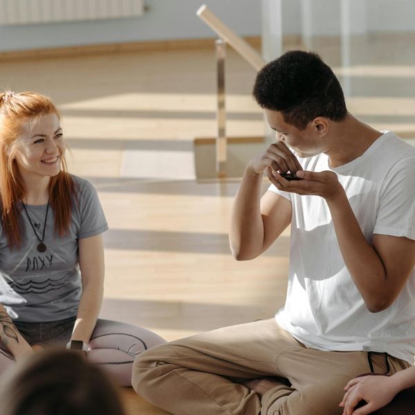 Group of diverse people practicing yoga in a bright studio.